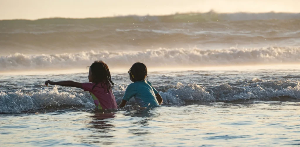 two children playing on the beach