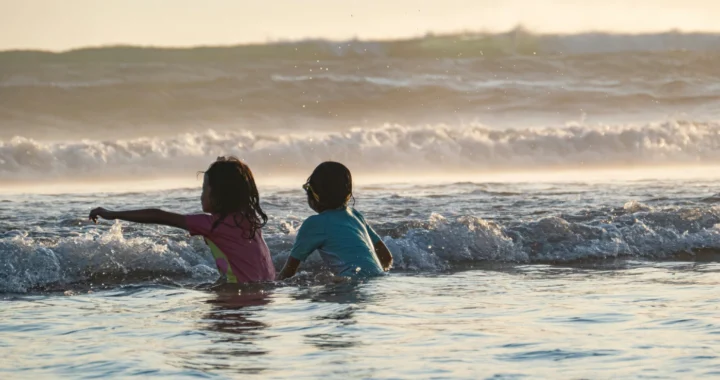 two children playing on the beach