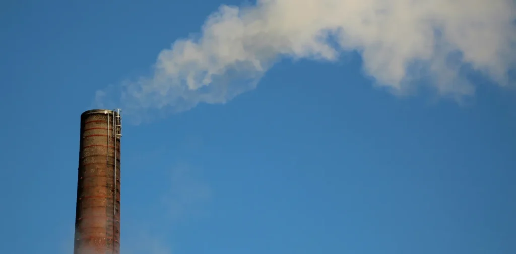 a factory funnel spewing out smoke