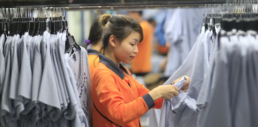 A young worker checks final products at a garment factory