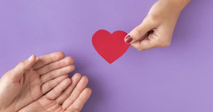 hand giving heart to other hands