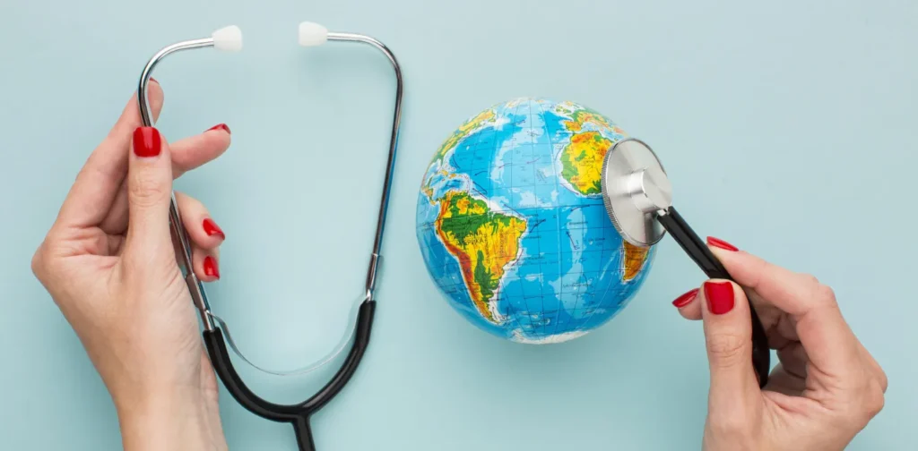 hands holding a stethoscope on a globe