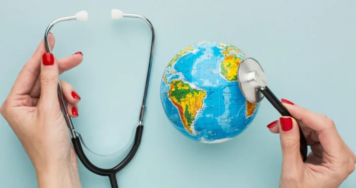 hands holding a stethoscope on a globe