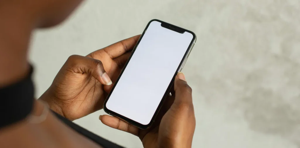 an over the shoulder photo of a person holding a phone