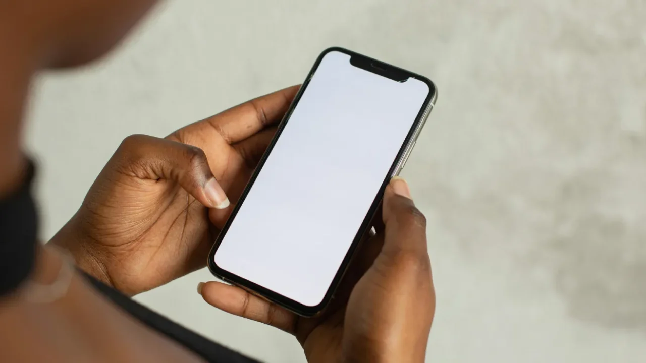 an over the shoulder photo of a person holding a phone