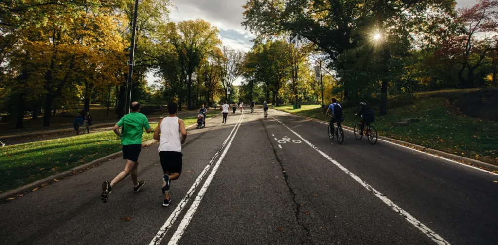 people running and biking at a park