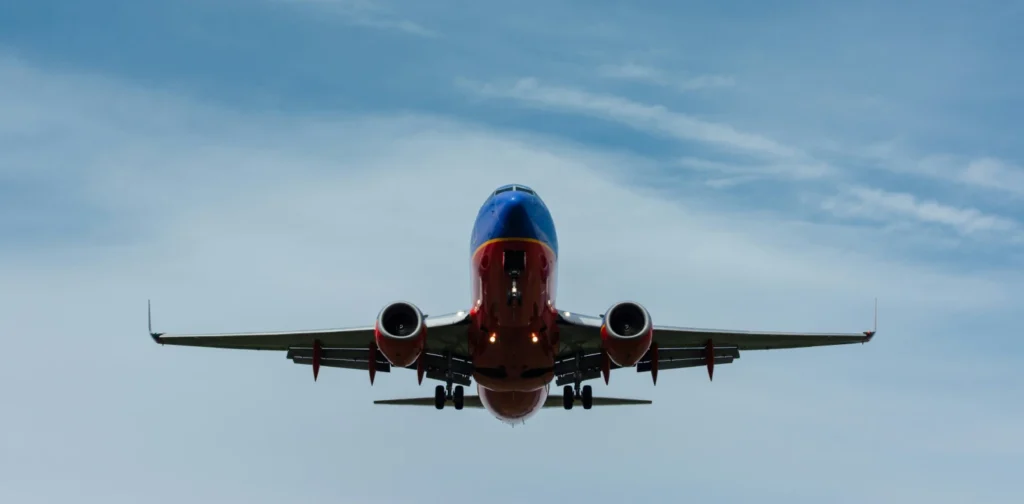 an airplane flying in the blue sky