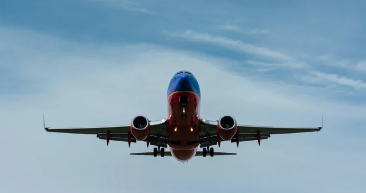 an airplane flying in the blue sky