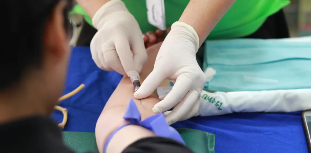 a person getting their blood checked by a healthcare worker