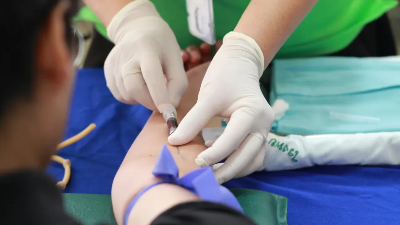 a person getting their blood checked by a healthcare worker