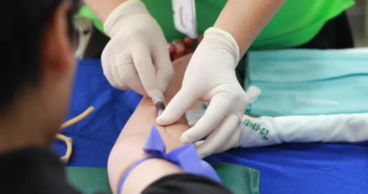 a person getting their blood checked by a healthcare worker