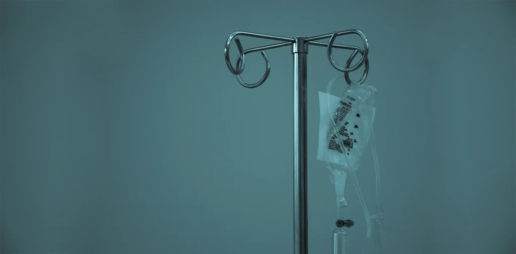 an IV drip hanging on a stainless steel stand