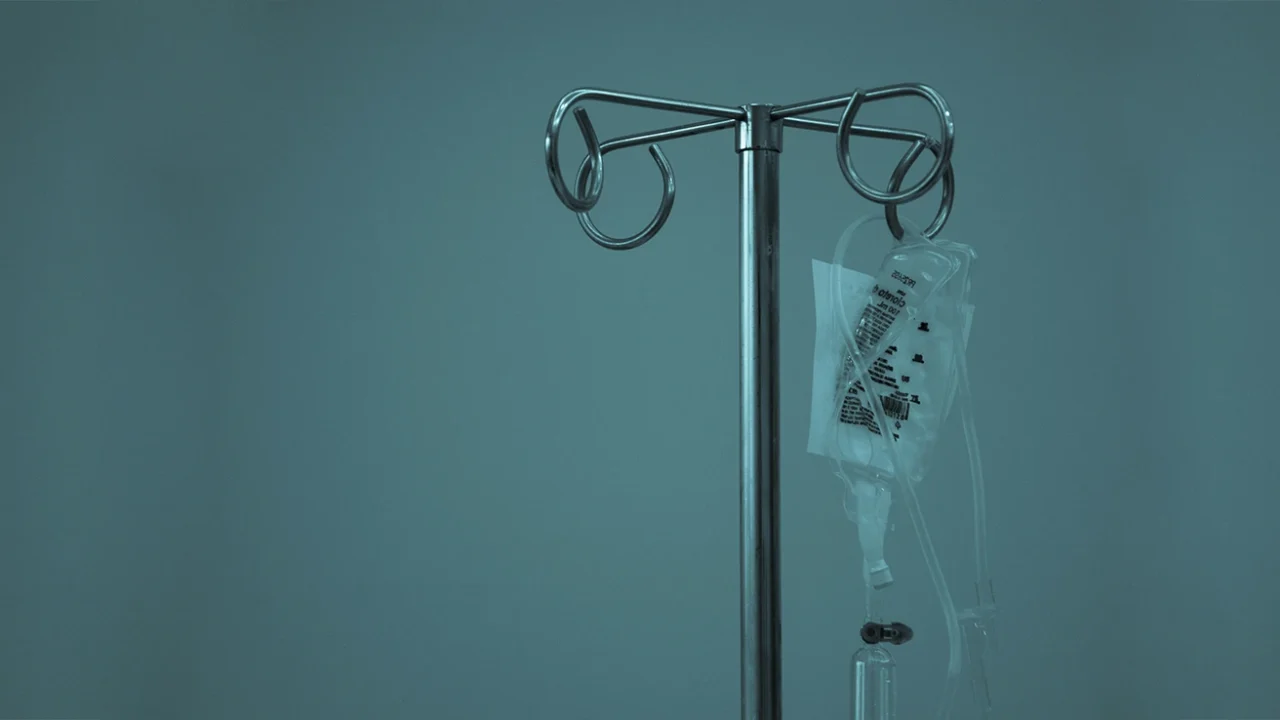 an IV drip hanging on a stainless steel stand