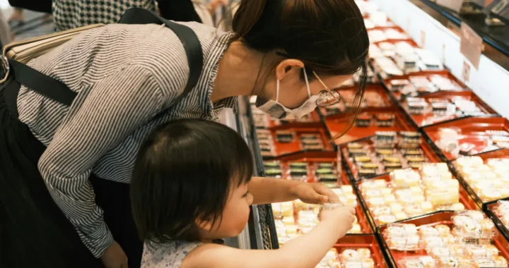 a mother and her daughter shopping for sushi