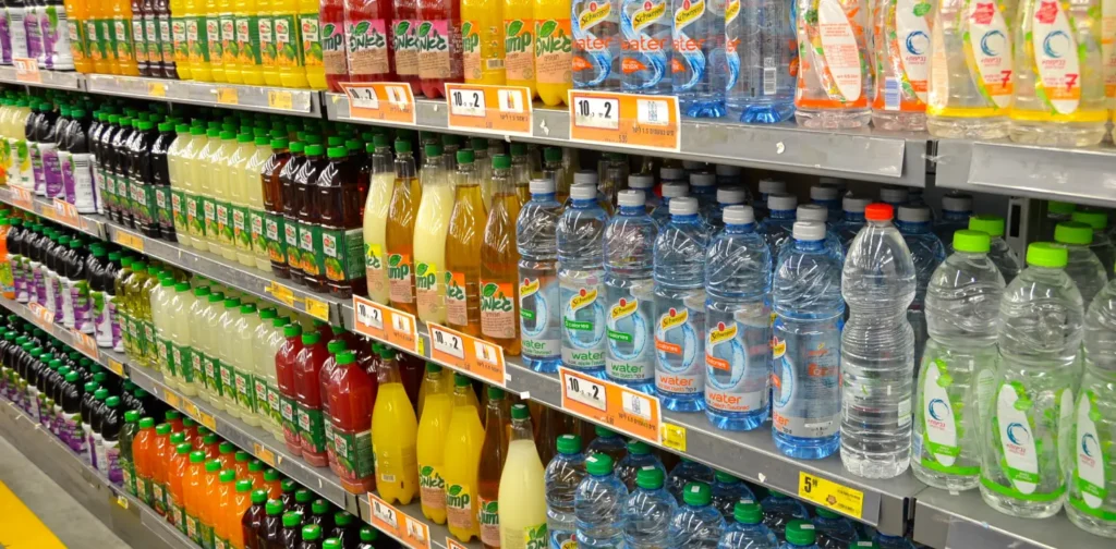 racks of plastic packaged beverages in a supermarket