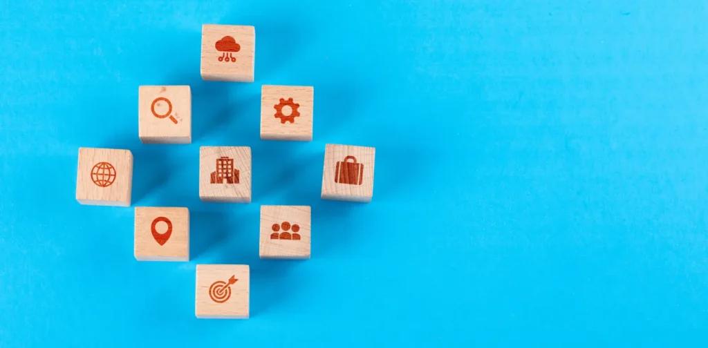 wooden blocks with icons against a blue backdrop