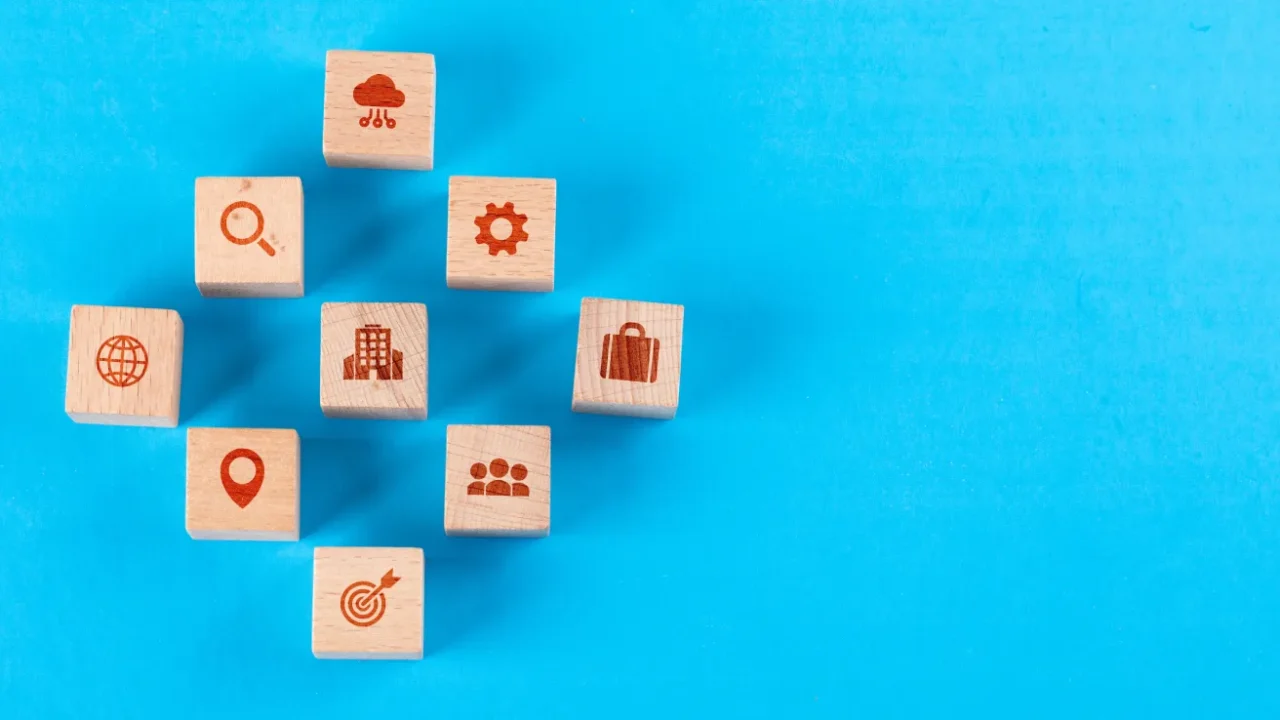 wooden blocks with icons against a blue backdrop