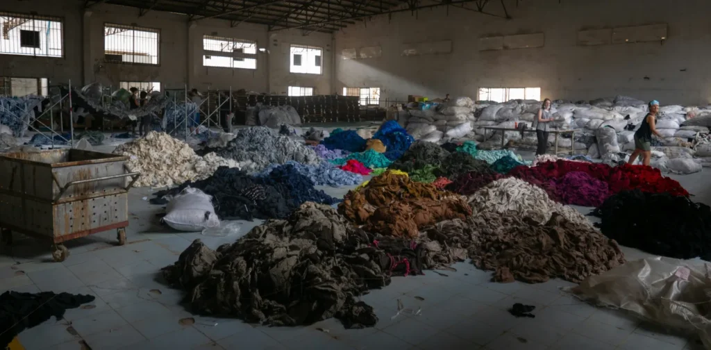 piles of colorful fabric inside a warehouse.