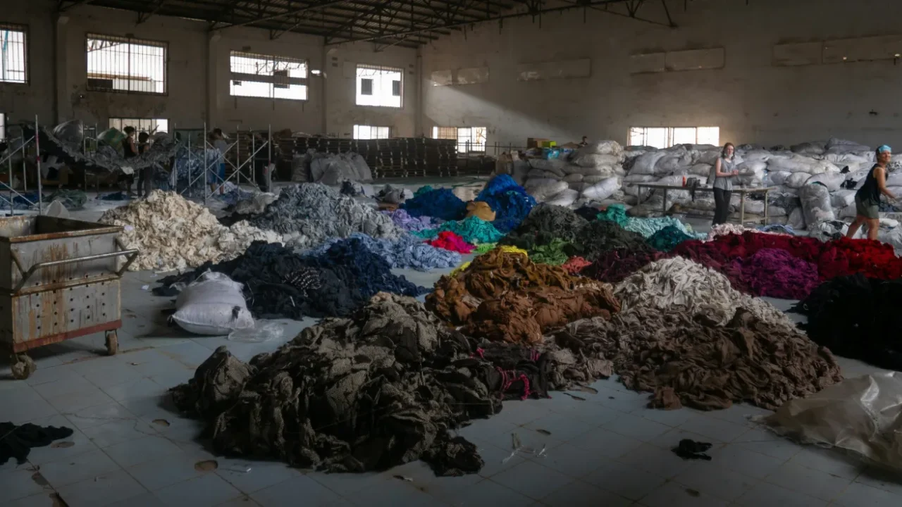 piles of colorful fabric inside a warehouse.