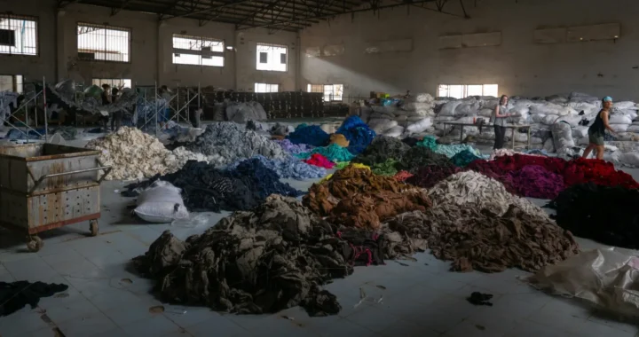 piles of colorful fabric inside a warehouse.