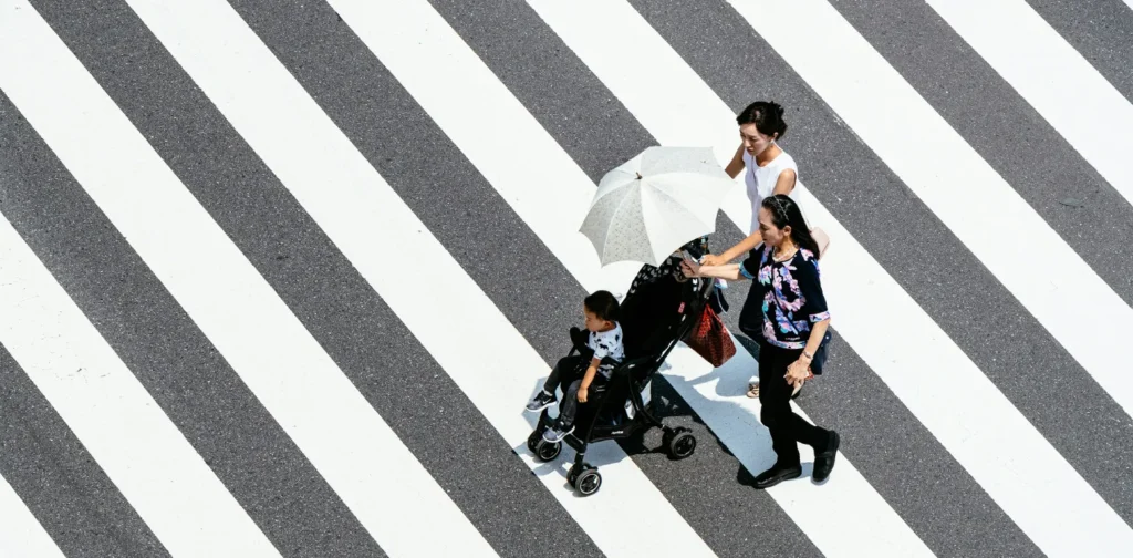 two women and a little girl walking hand-in-hand