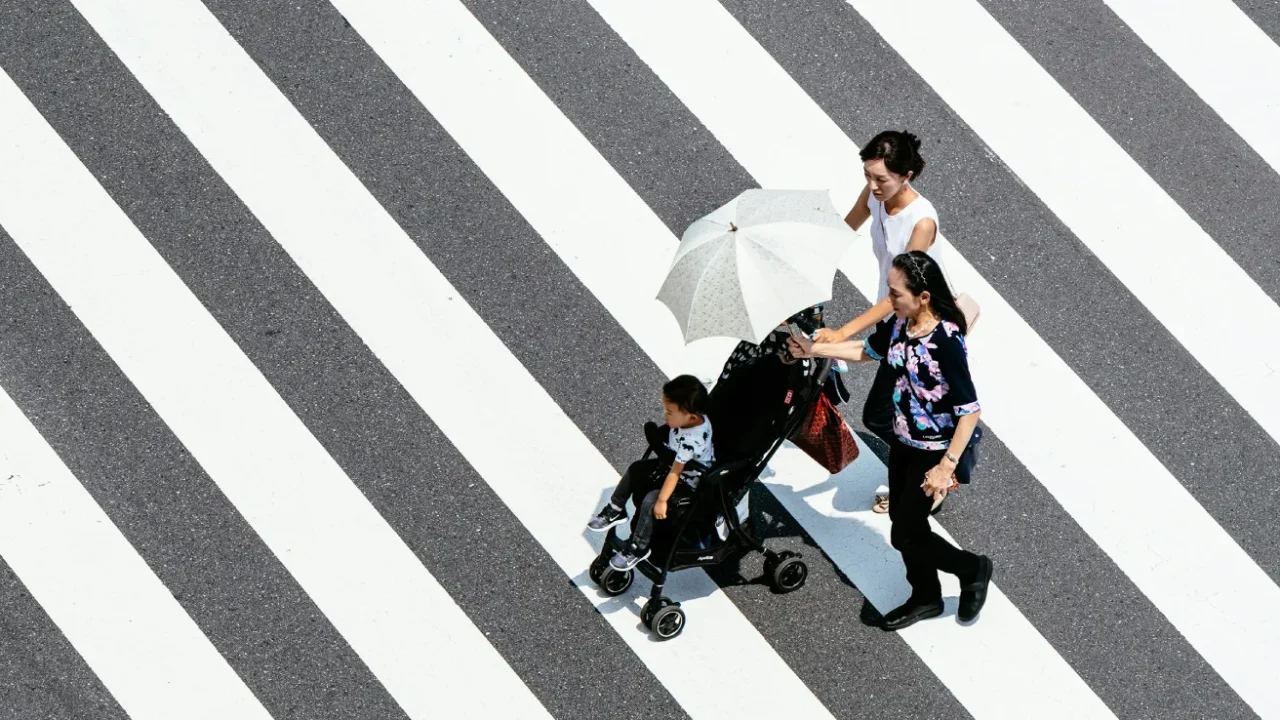 two women and a little girl walking hand-in-hand