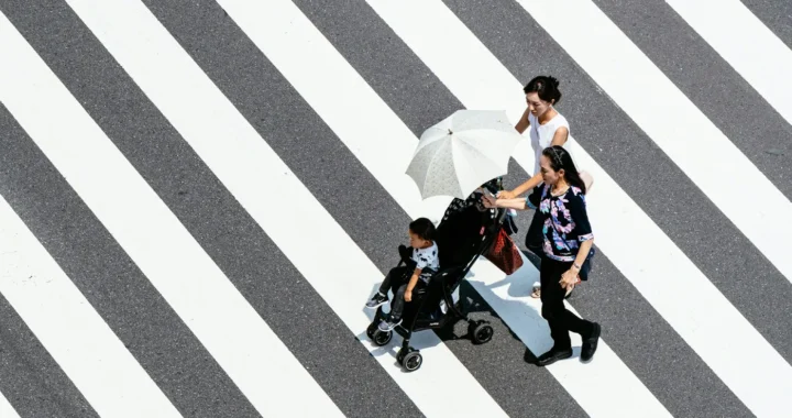 two women and a little girl walking hand-in-hand