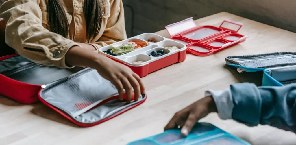 two school children eating lunch