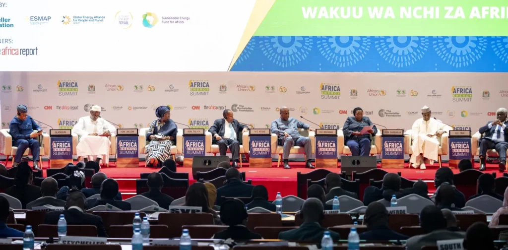 country leaders sitting on a podium in front of a forum