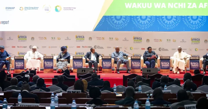 country leaders sitting on a podium in front of a forum