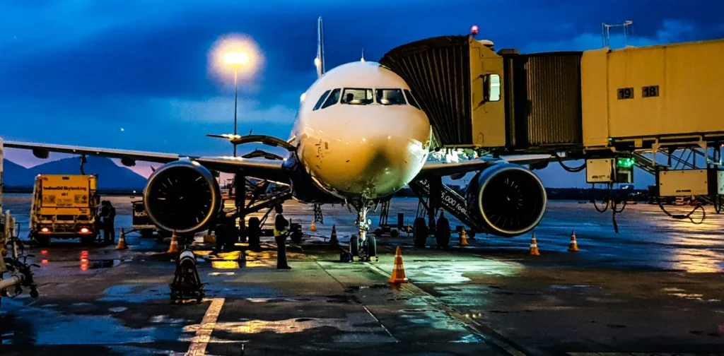 a photo of a white airplane stationed at the airport