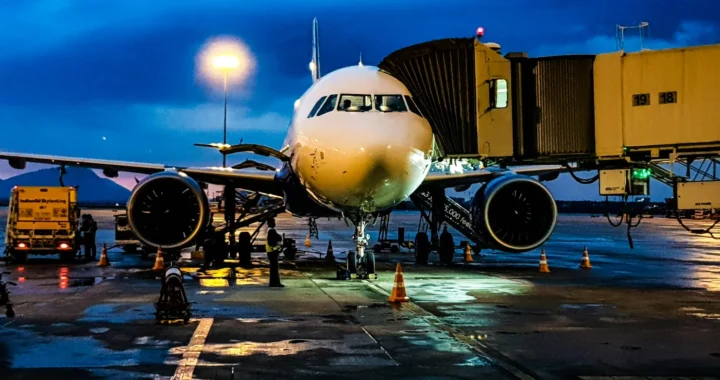 a photo of a white airplane stationed at the airport