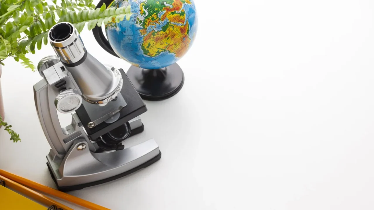 a book, a microscope, and a globe