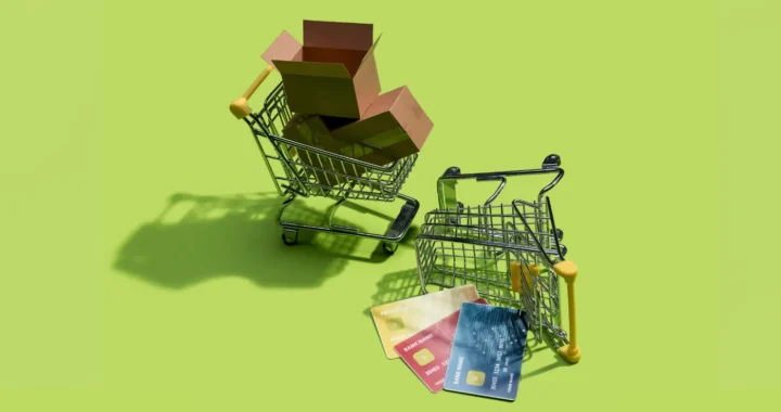 A toppled miniature of a card with empty boxes and credit cards spilling out