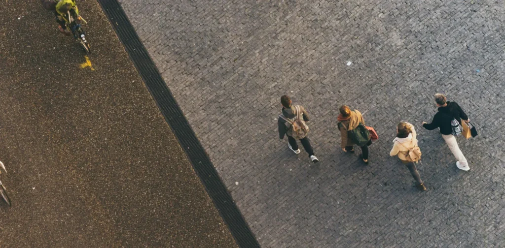 a photo of people walking and cycling, shot from above