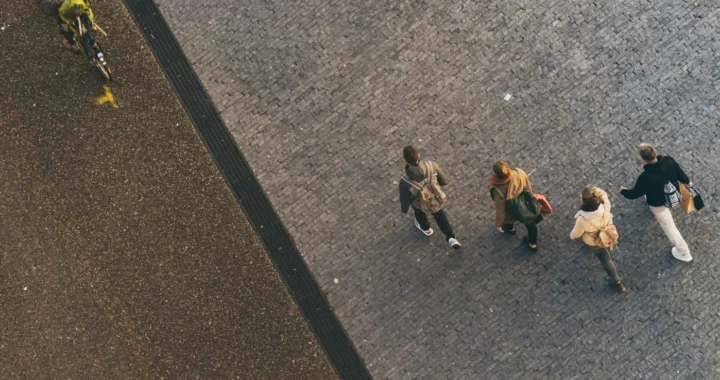 a photo of people walking and cycling, shot from above