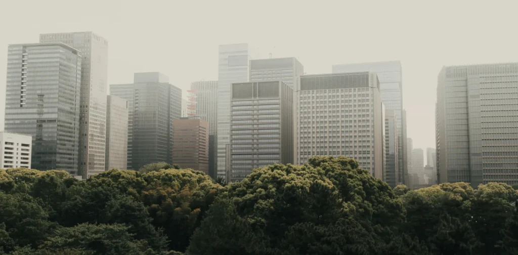 a photo of trees in front of tall buildings