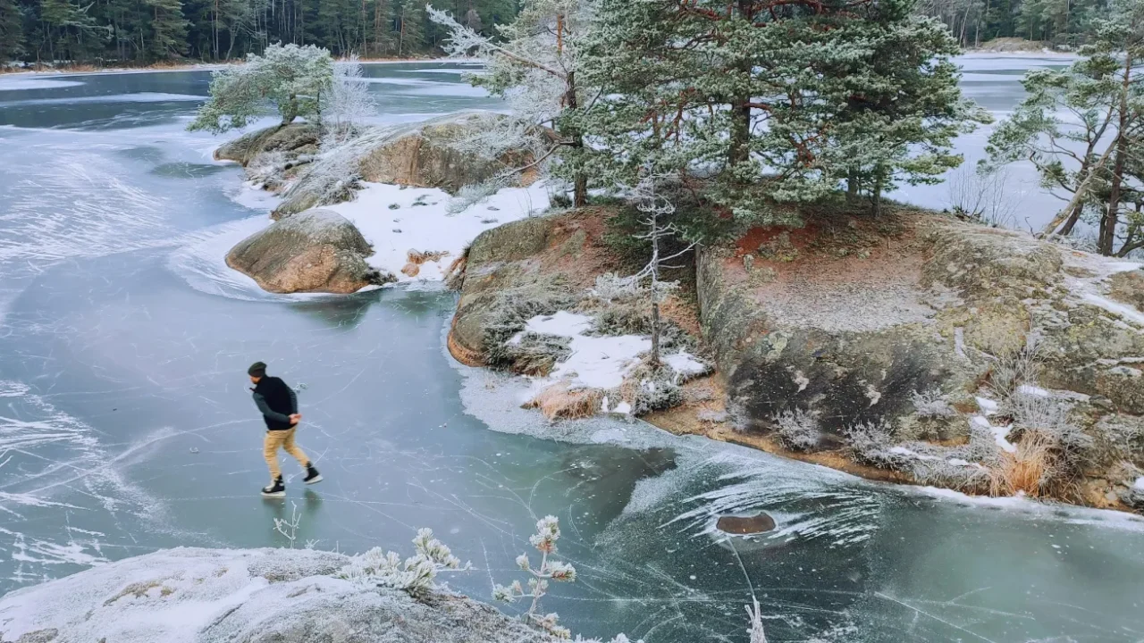 man skiing on frozen lake