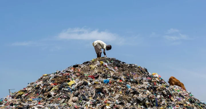 a man on top of a garbage dump
