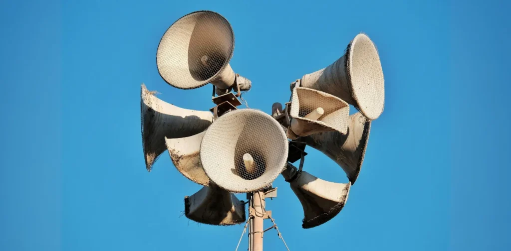 multiple megaphones attached on a pillar