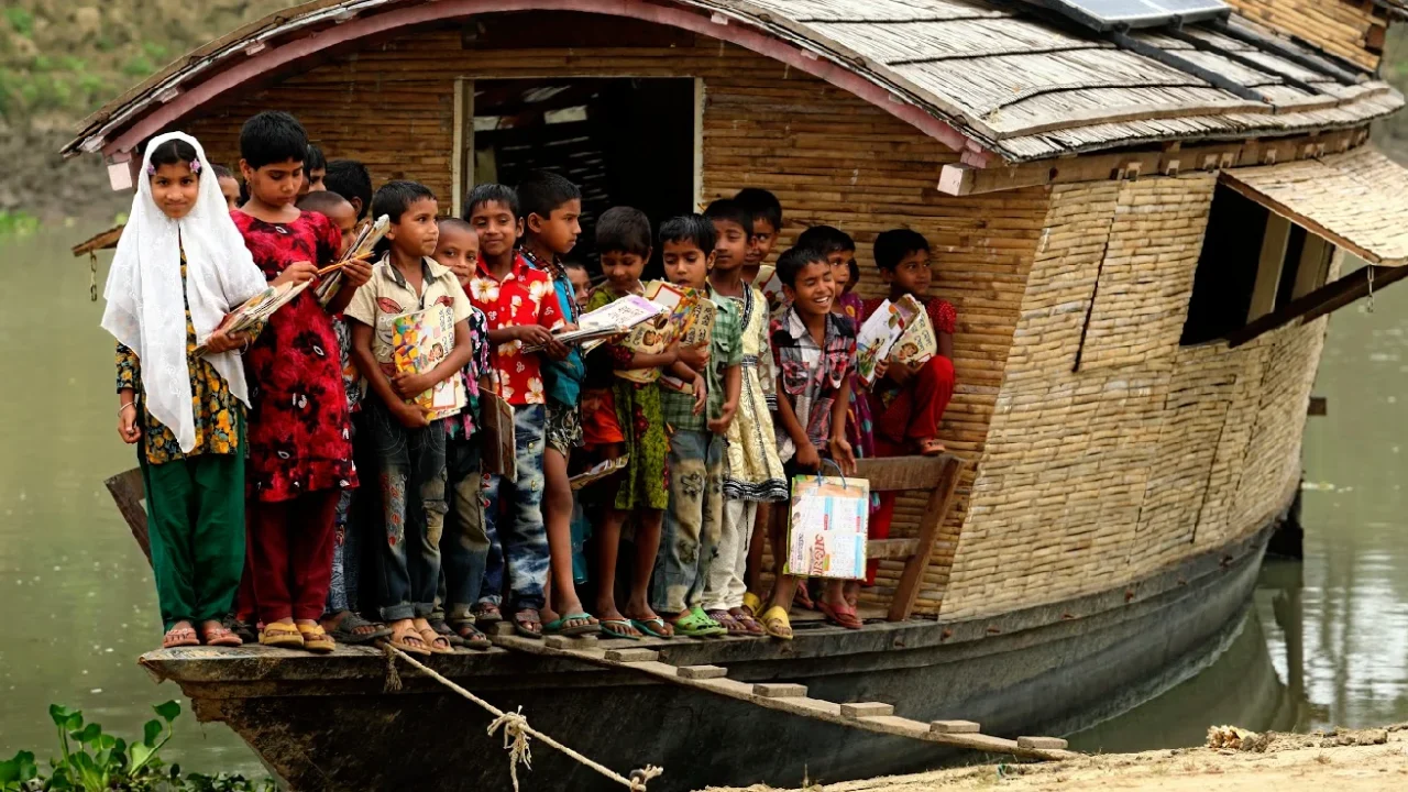 a group of children with studying items on a boat