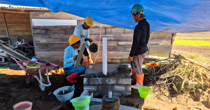 Three men are building a biogas facility.