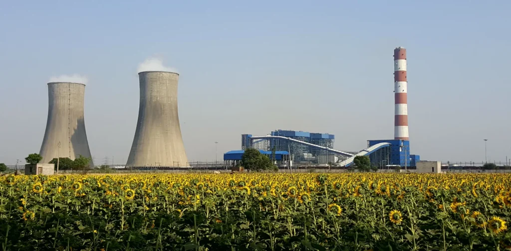 thermal power plant in india with smoke coming out of the stacks