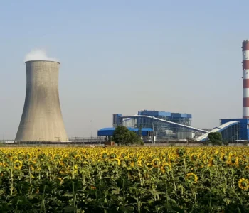 thermal power plant in india with smoke coming out of the stacks