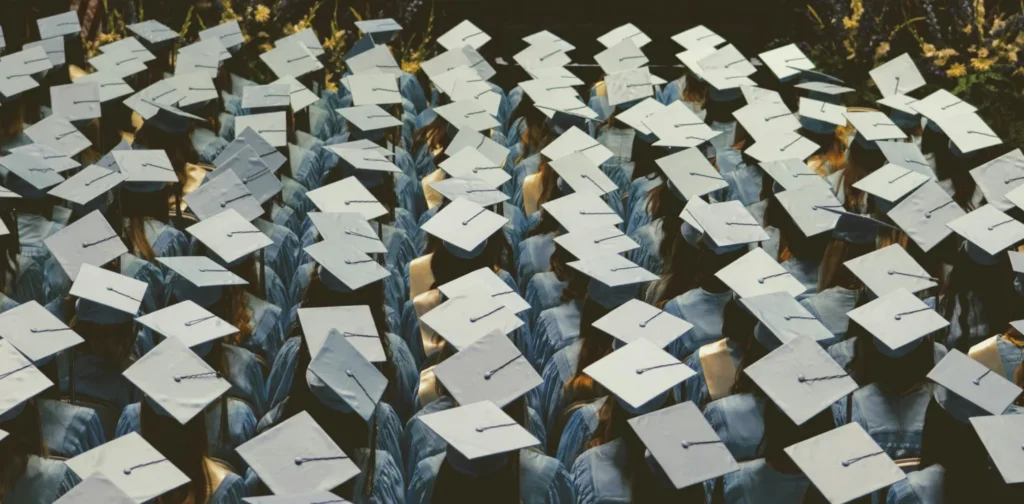 A graduation cap symbolizes the growing number of graduates facing limited job opportunities.