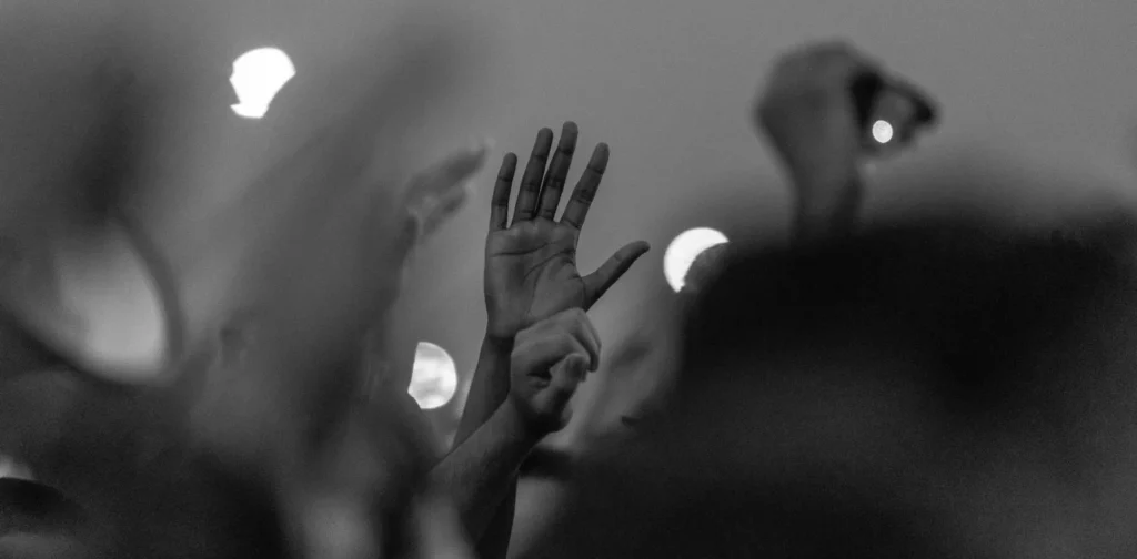 a grayscale photo of a raised hand