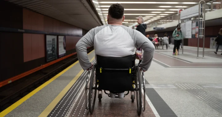 a man with disability pushed wheelchair on train platform