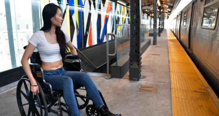 a woman with disability pushed wheelchair on train platform