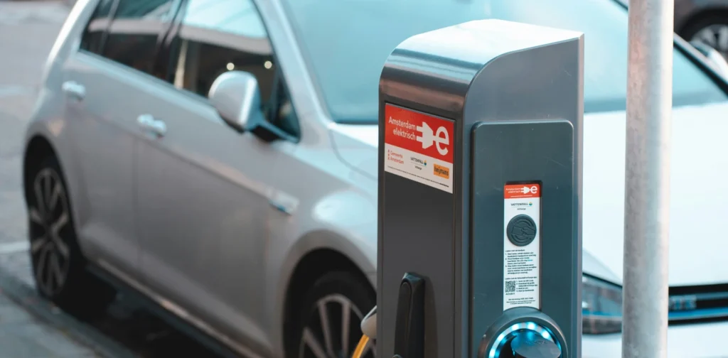 a charging station with an electric car parked next to it.
