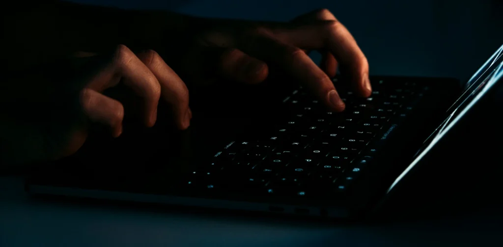 a person typing on their laptop